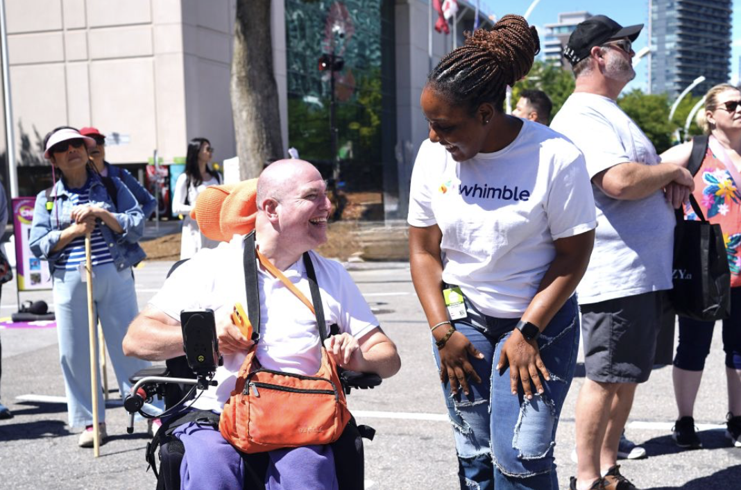 This is a picture of our client with one of our attendant. They are smiling at each other at the Toronto CNE.