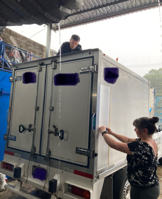 CEO Dr. Romy Fain installing our thin film on the side of the test truck in Mérida, Mexico.