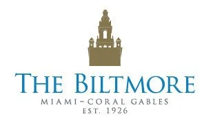 Logo of The Biltmore Miami-Coral Gables featuring a gold domed tower and blue text.