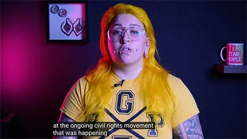 Still from a video where Lynn Loheide is discussing Michelle Handelman