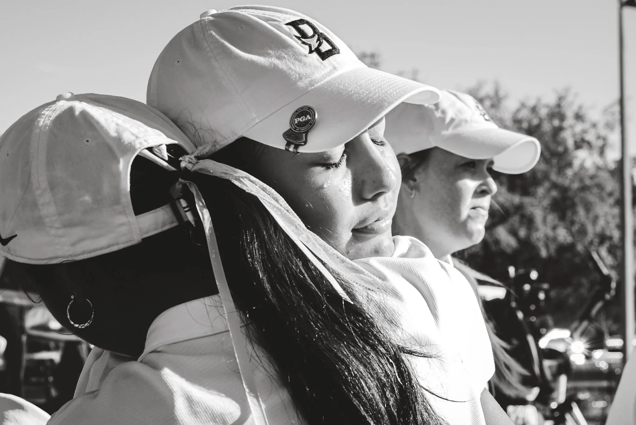 Sofia Rivera in Beachside High School Athletics Uniform white cap with Logo crying after teams victory on State Championship Florida Black and White