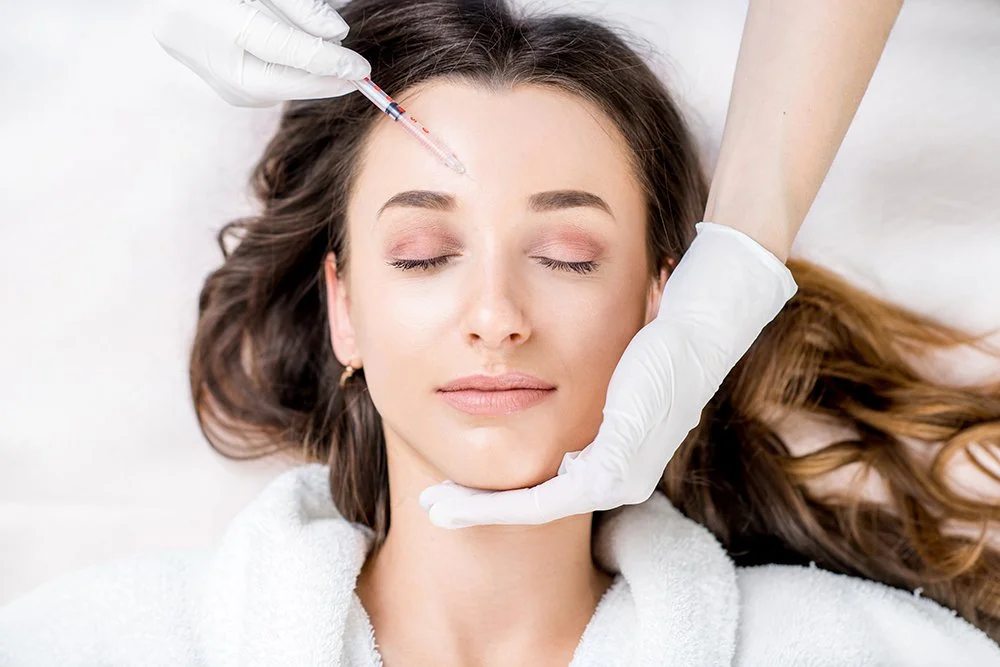 woman getting botox injected into forehead