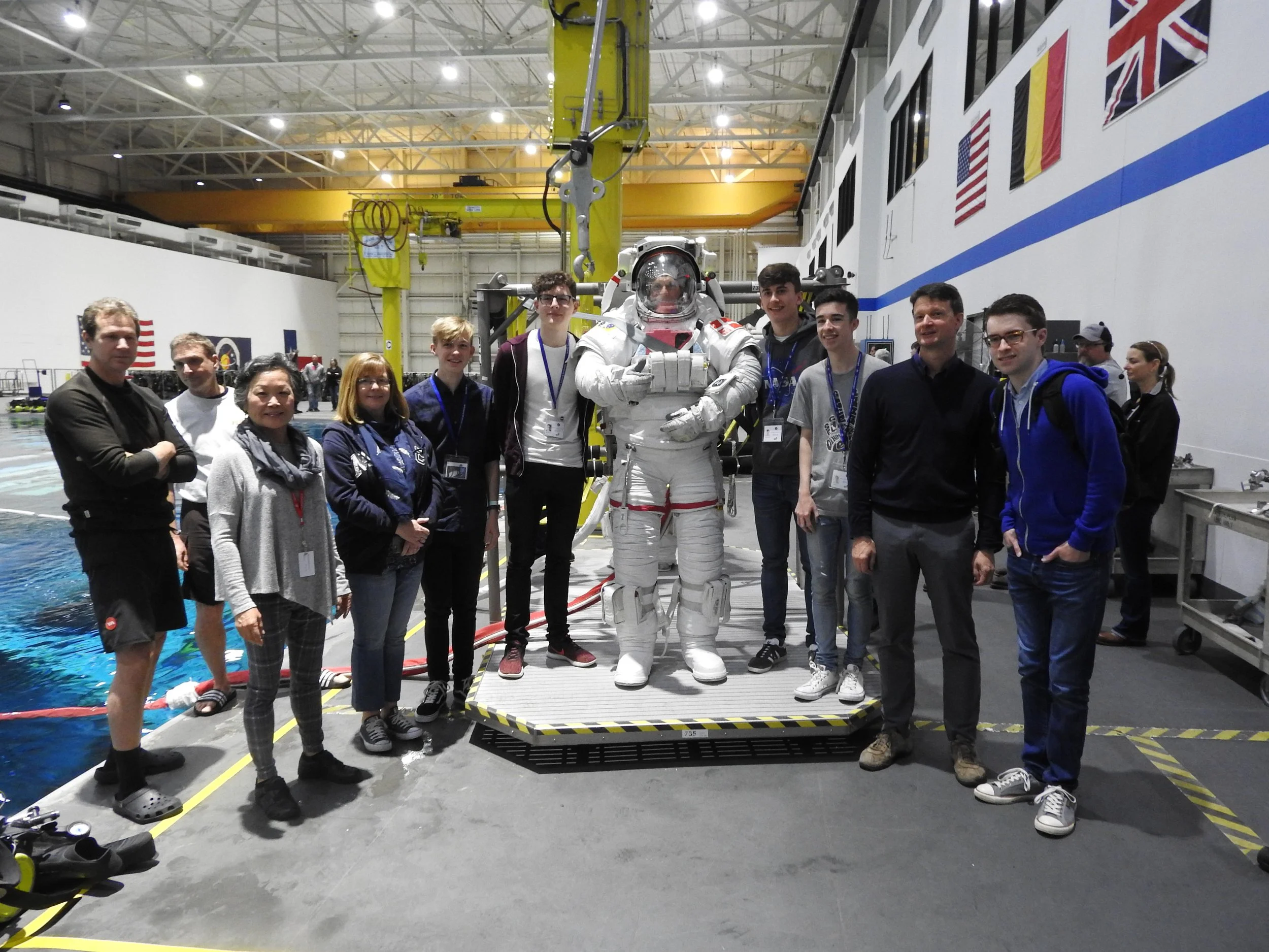 A photo of me and my fellow Space School alumni standing with an astronaut about to undergo training in the Neutral Buoyancy Laboratory.