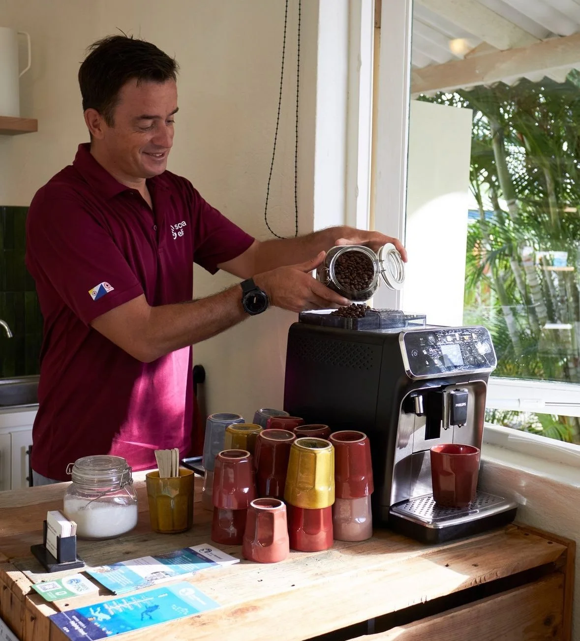 Founder of Scuba Elite Pascal van Empelen takes care of his guests by refilling the coffee beans