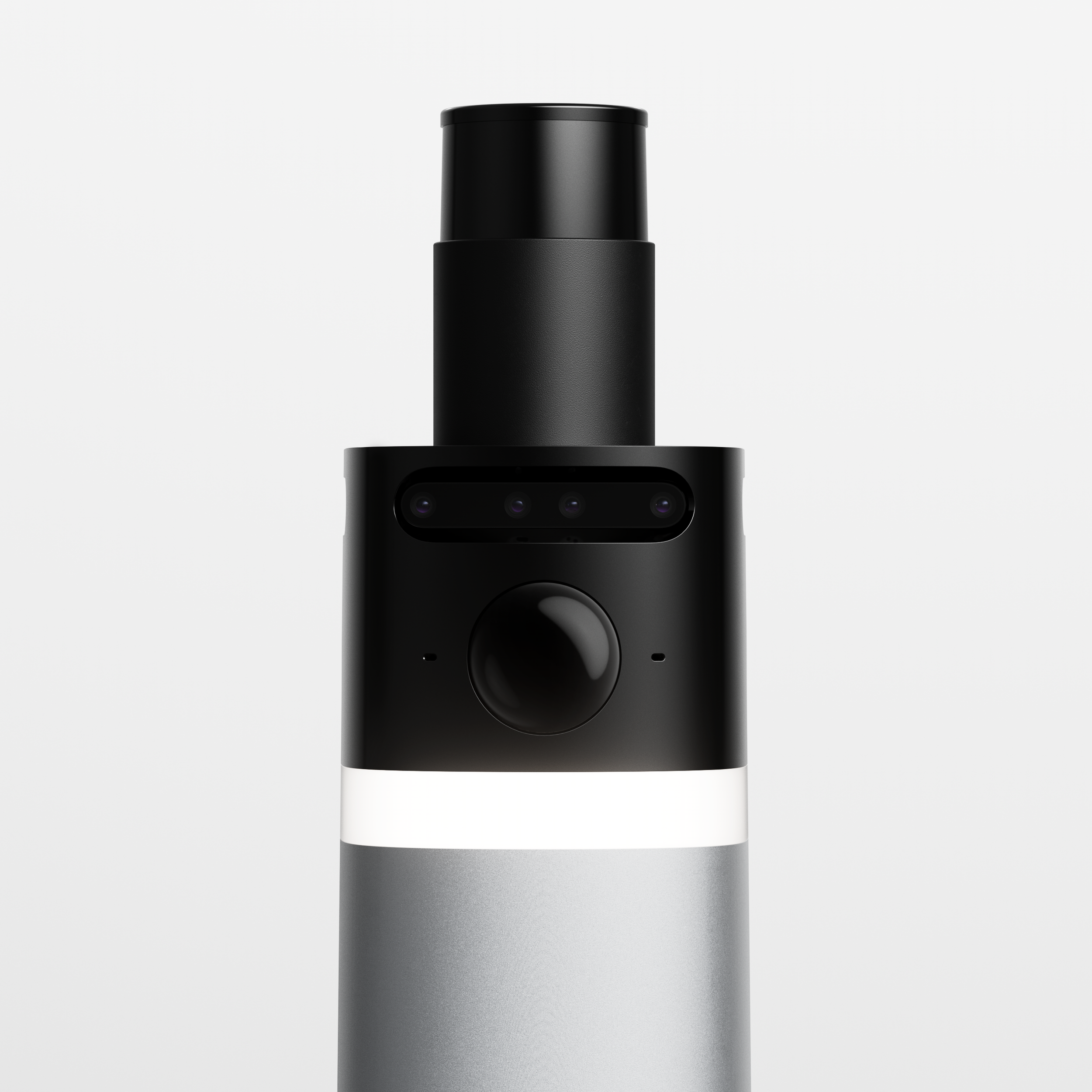 Close-up of a sleek, black, modern electronic device with a cylindrical top and a rectangular display area with three camera lenses underneath, set against a plain gray background.