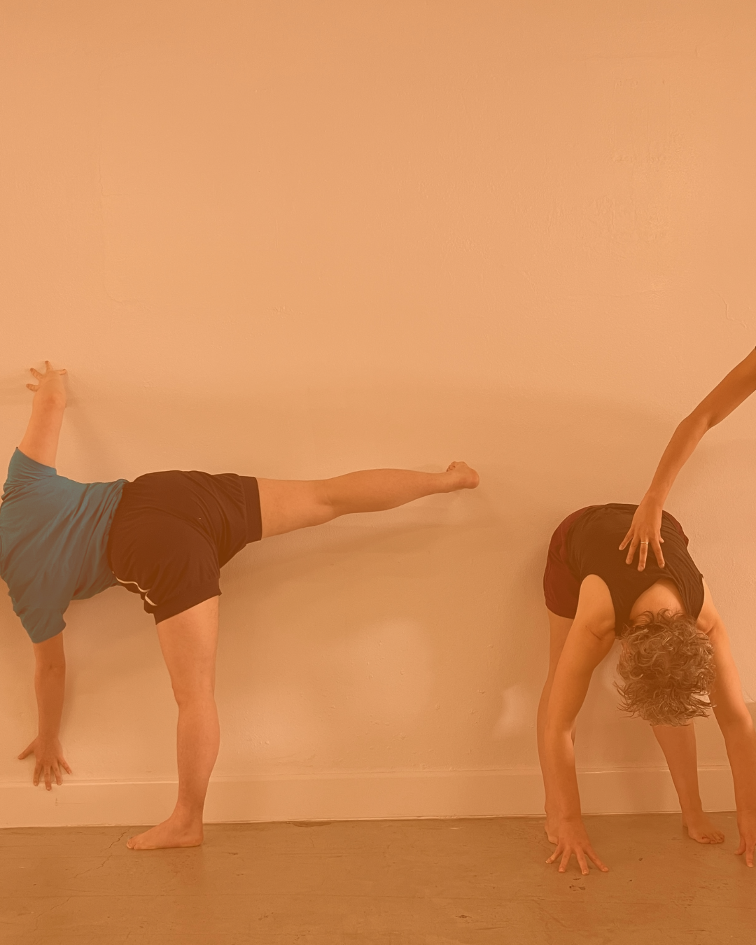 Person's legs supported by yoga ropes against a wall.