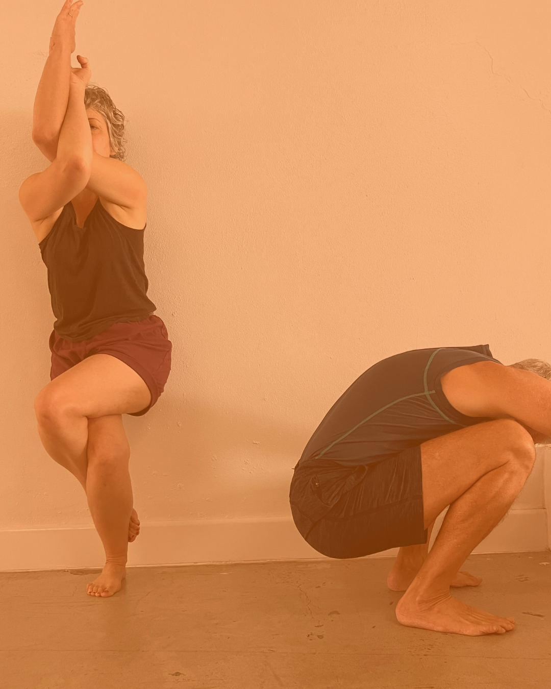 Close-up of hand holding beige braided ropes in a bright room with wall hooks, possibly for yoga or exercise.