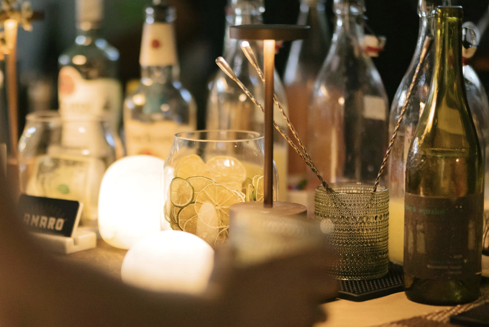 Cocktail bar setup for a wedding at night. Elevated presentation for wedding reception bar.