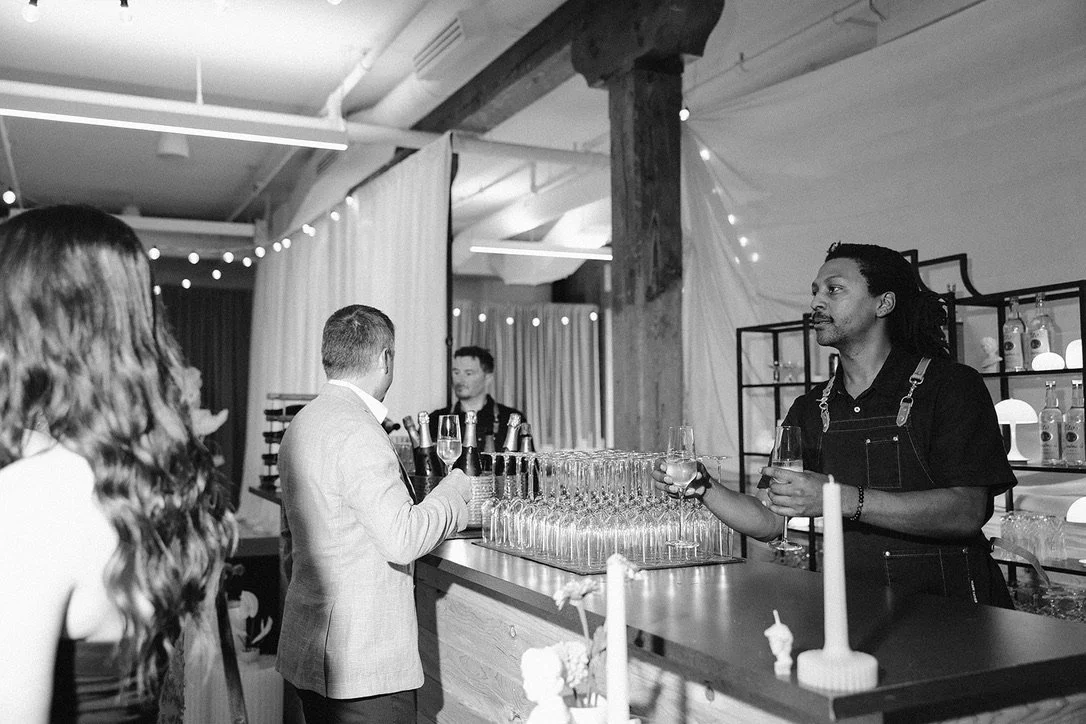 Bartender and guests at wedding reception