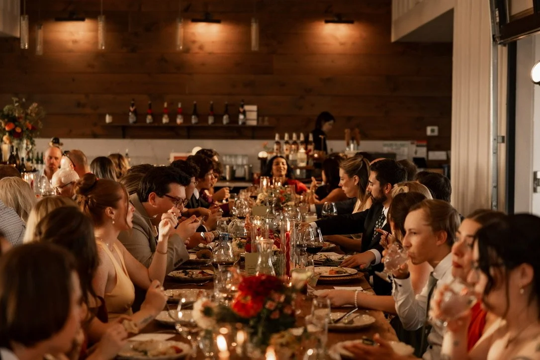 Guests gathered around table at wedding reception