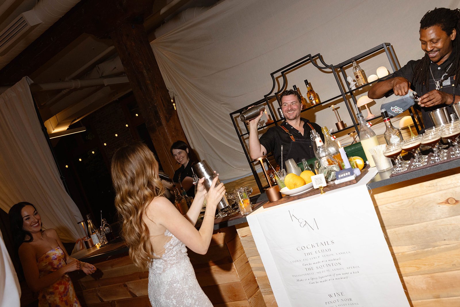 Bride shaking drink at wedding reception