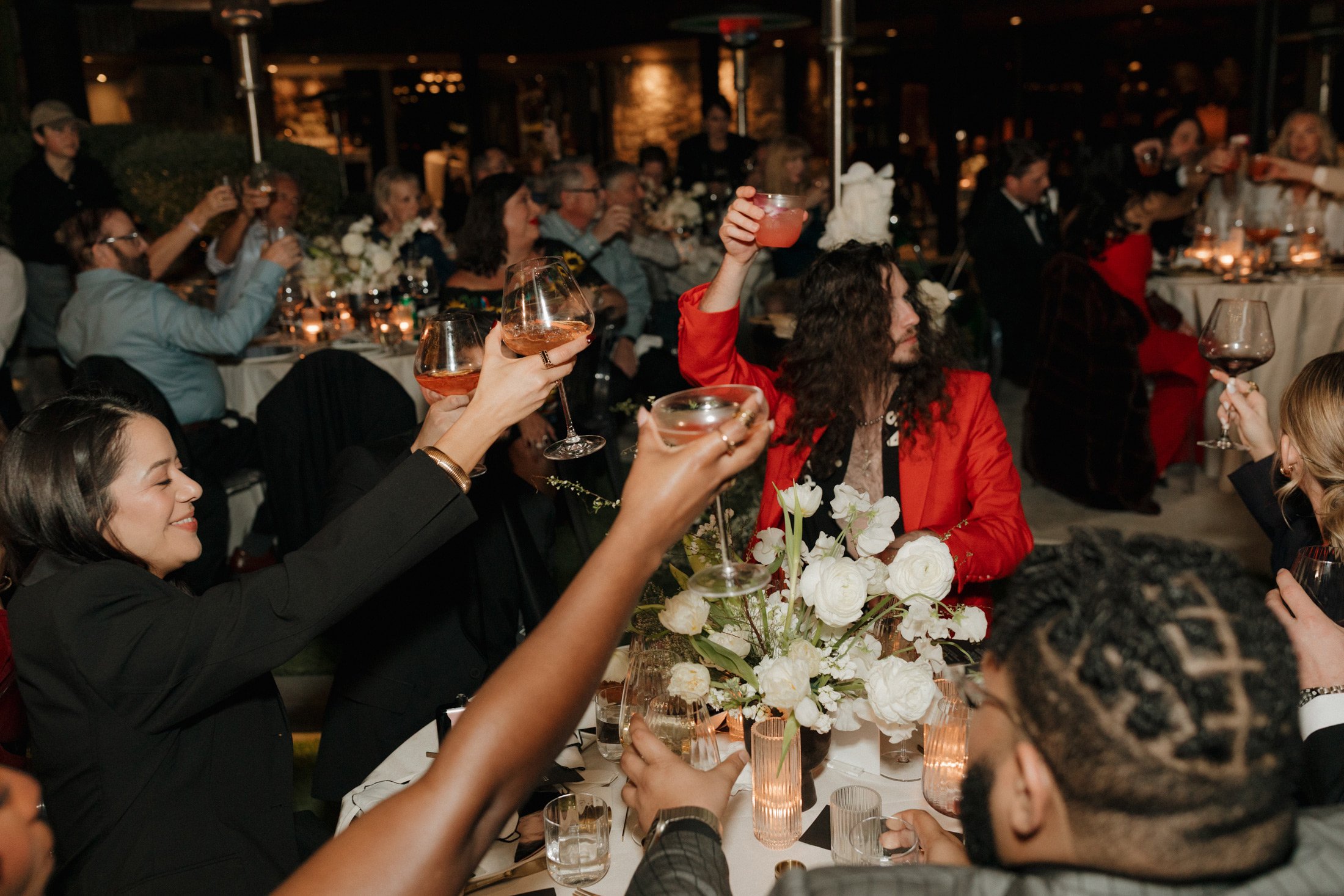 Guests toasting cocktails at a wedding reception catered by a Palm Springs bartending service