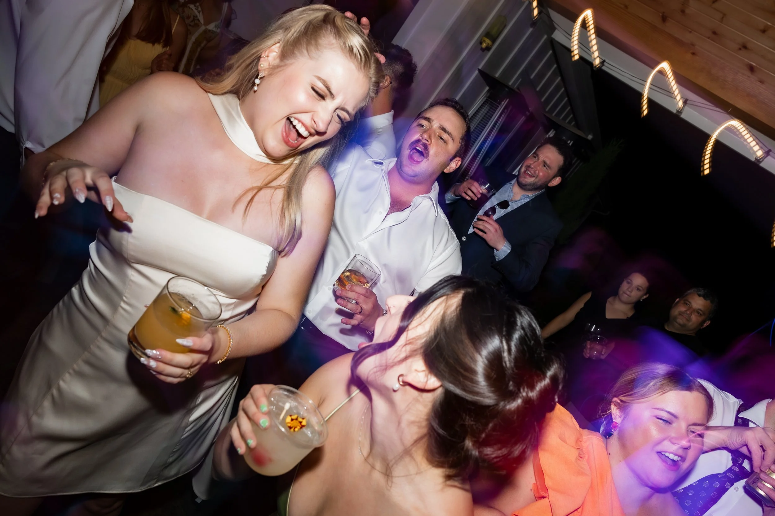 People dancing at a wedding reception catered by Amaro, a mobile event bartending service.