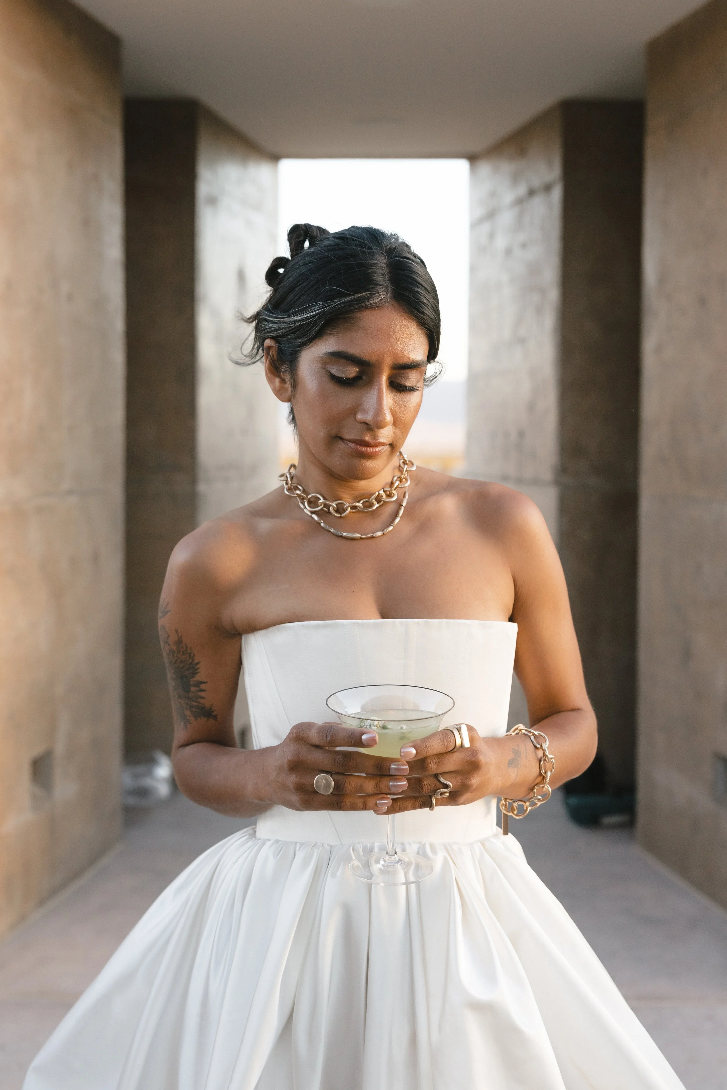 Elegant bride holds a cocktail in Coachella Valley