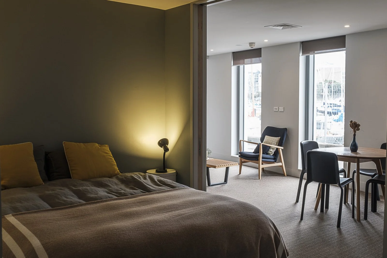 Bedroom space, with dining area visible