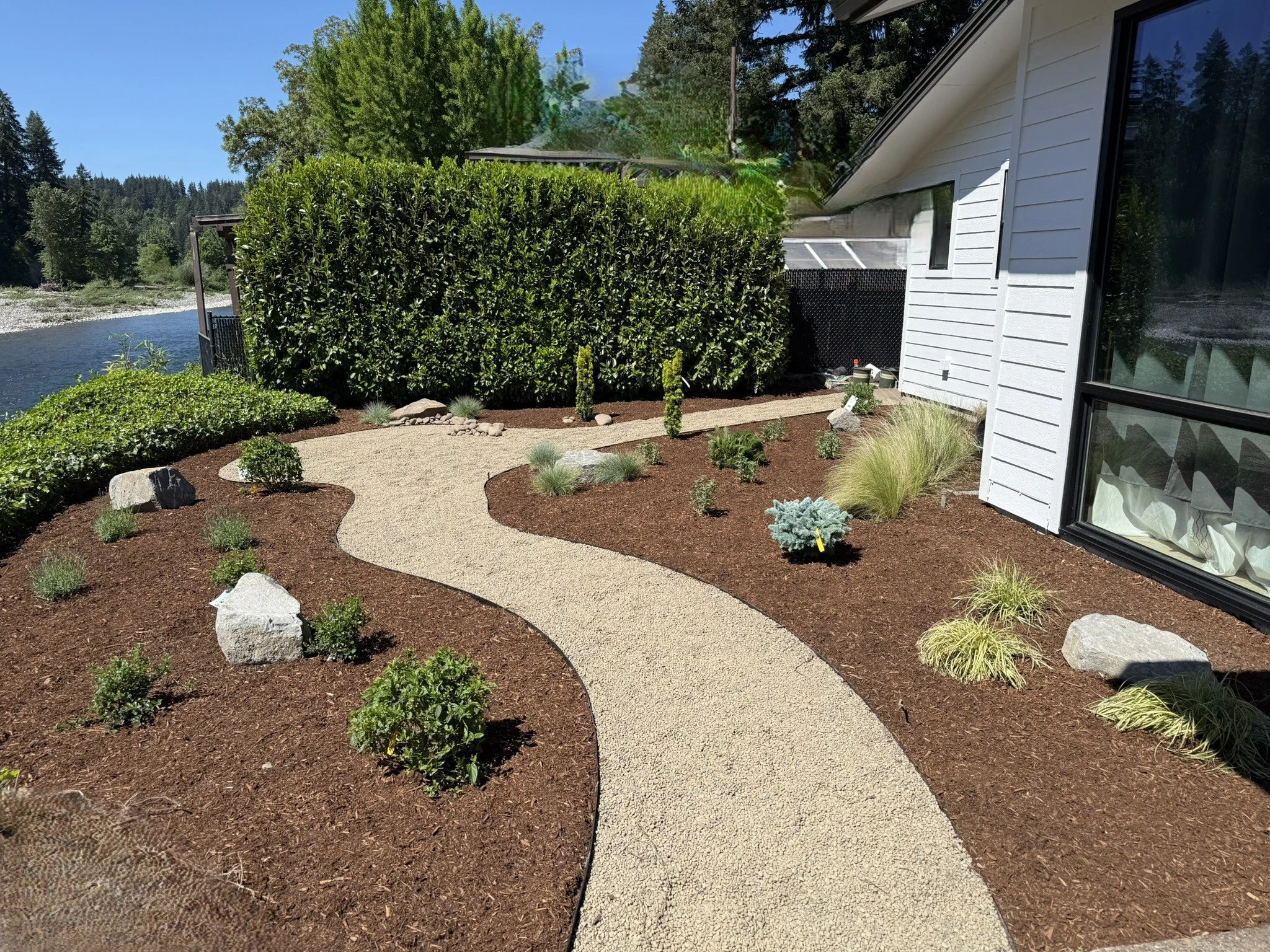 Landscape pathway, barkdust, boulders, and plantings. 