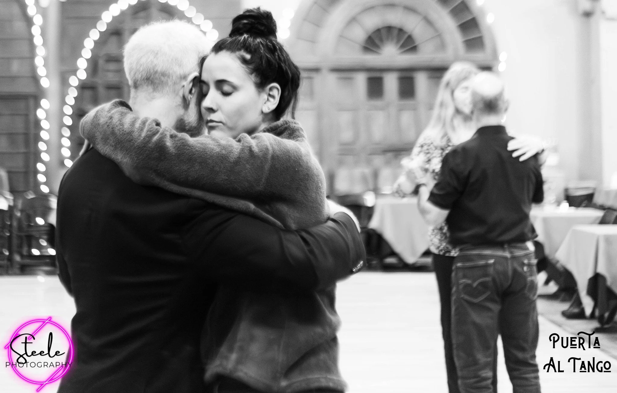 Tango Ongoing classes with Puerta al Tango. Graham Stanford (owner, teacher) dancing with coach Dalila.  Tango Ongoing classes further our experience and understanding of the co-creative dance.  At Las Puertas in Albuquerque, New Mexico.