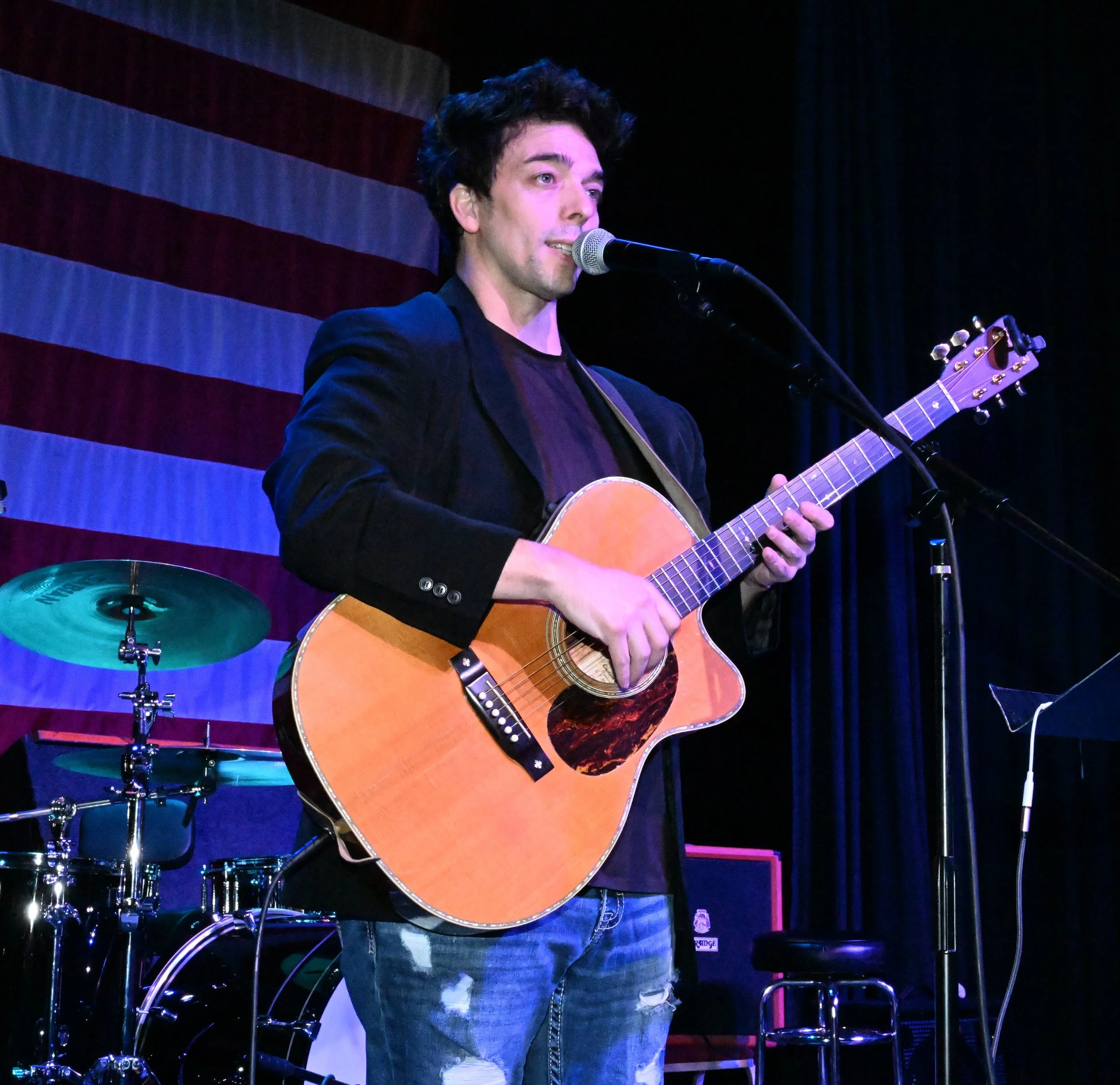 Sean Guerrero performing live with acoustic guitar