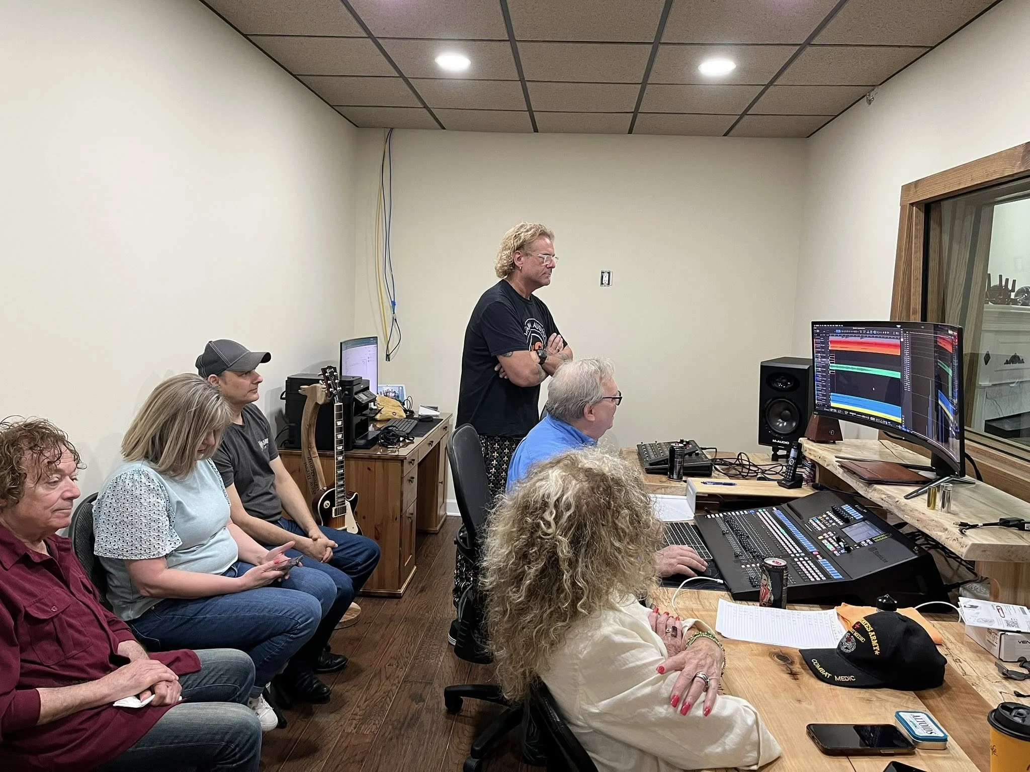 Recording session in the New Breed Productions control room with musicians and professional studio equipment