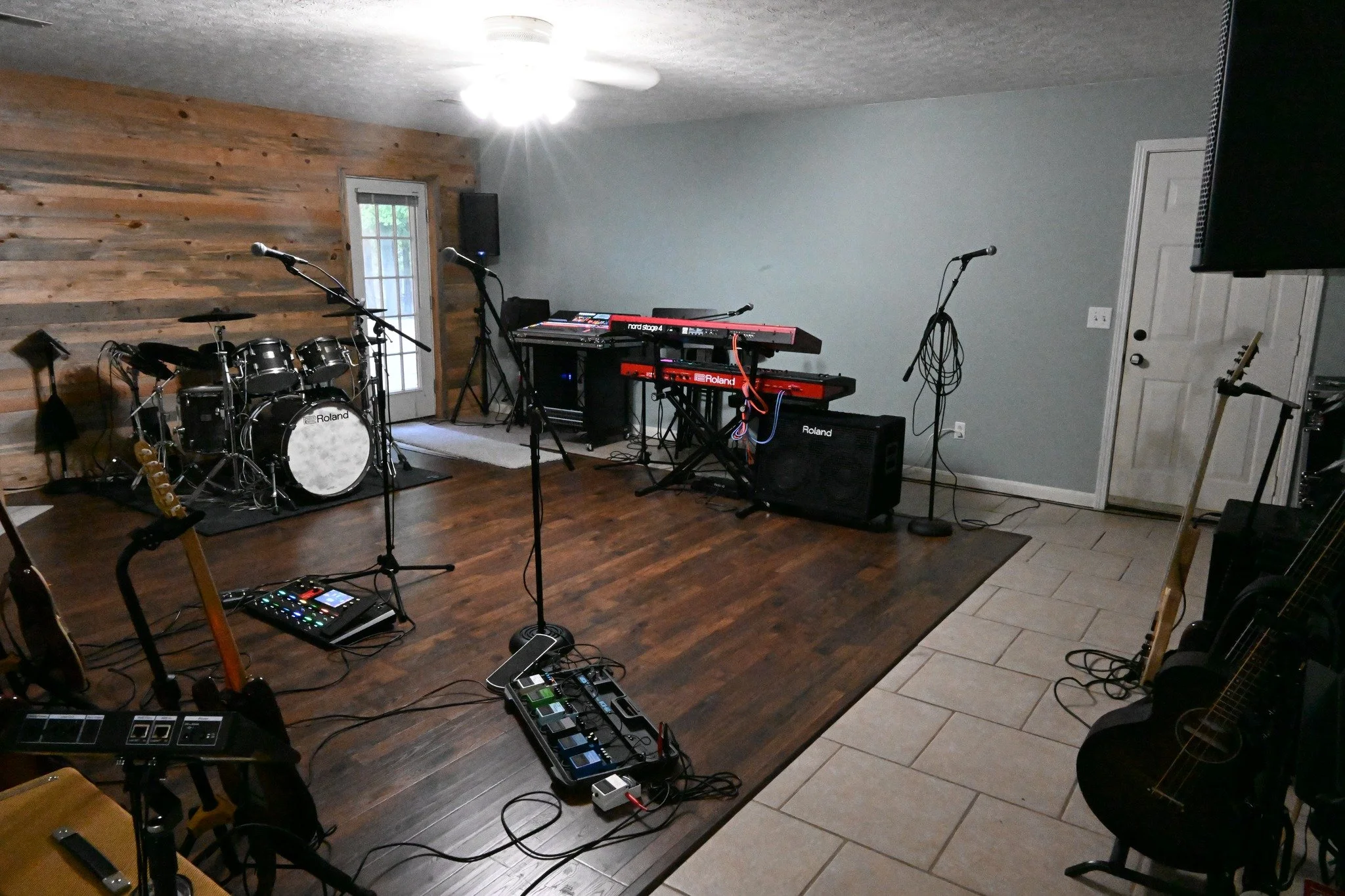 Professional tracking room at New Breed Productions with drums, keyboards, microphones and recording equipment