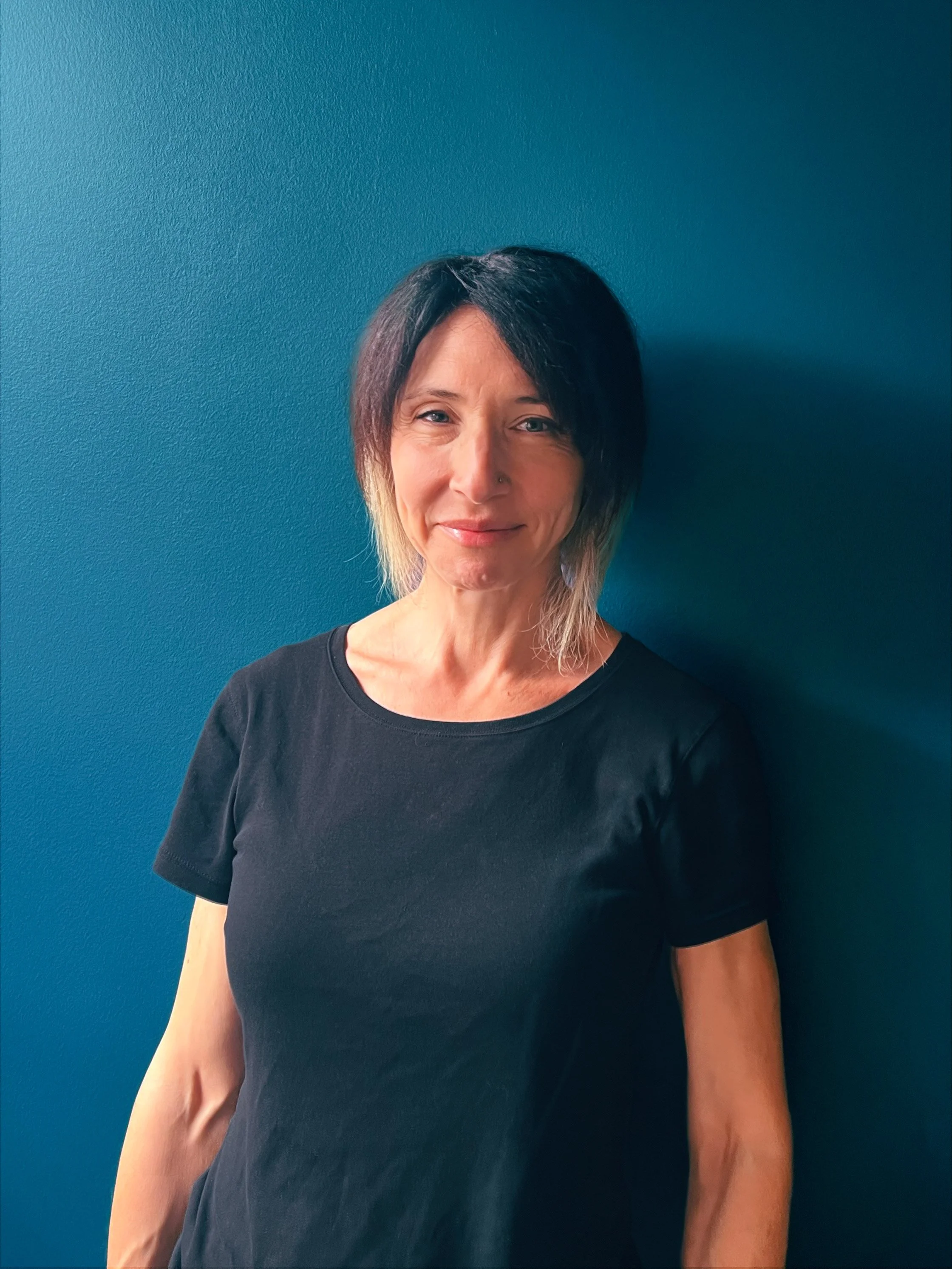 Jessica Siegel, LMT at Soul Sprout Acupuncture, smiling in a treatment room.
