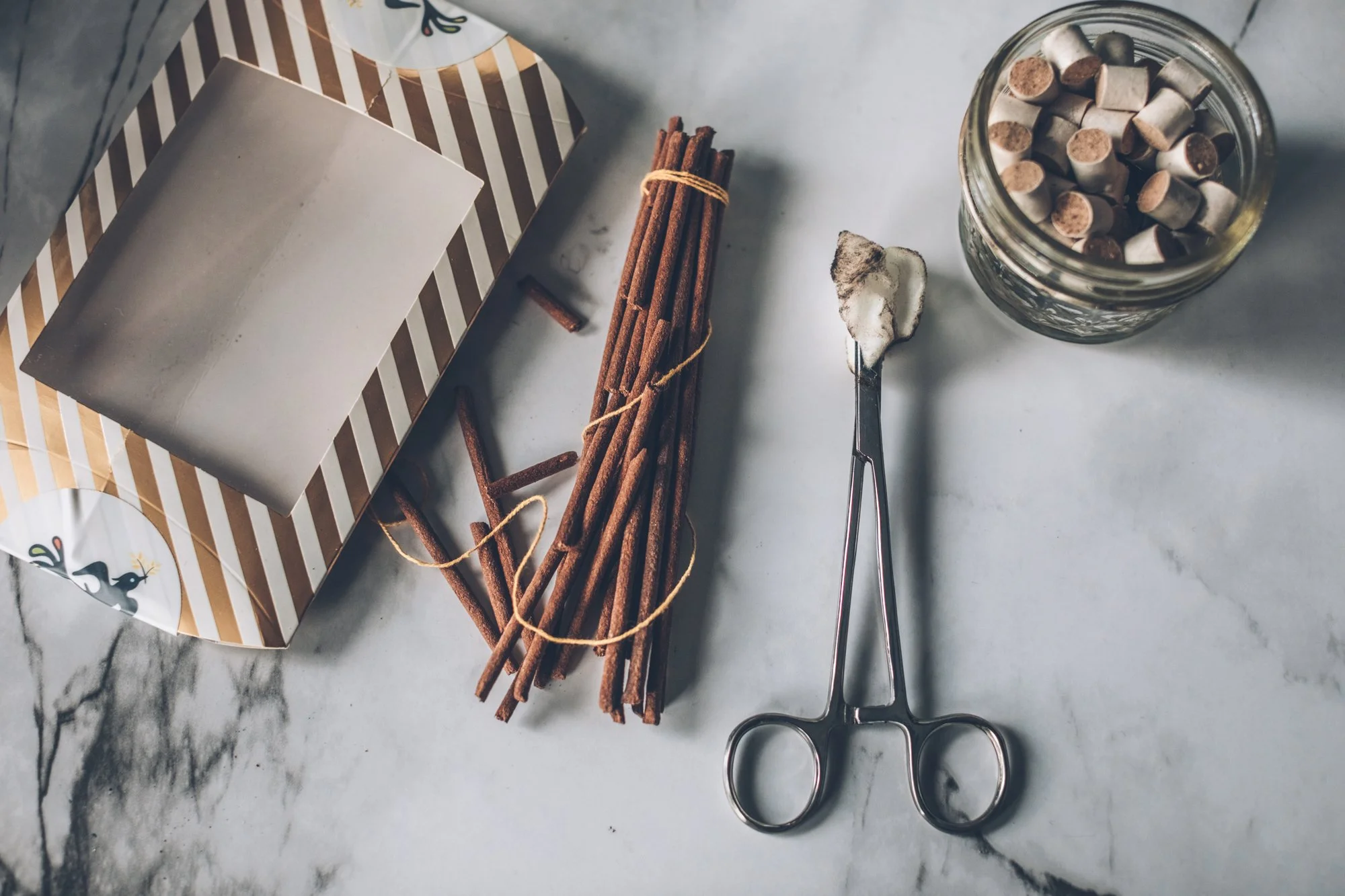 Moxi, incense and cupping tools laid out on a marble counter.