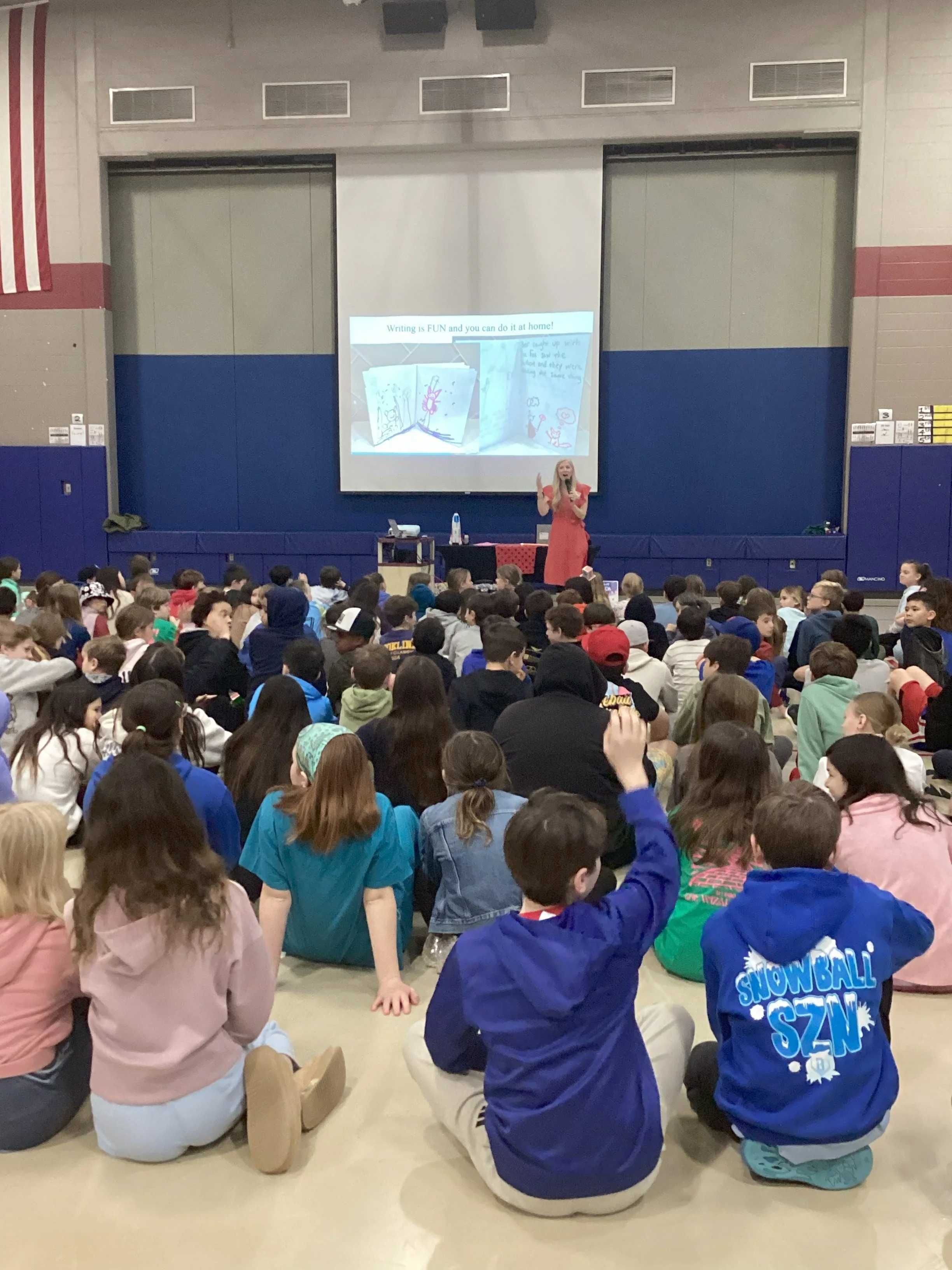 Author visit with Melissa Trempe in a large assembly with students.