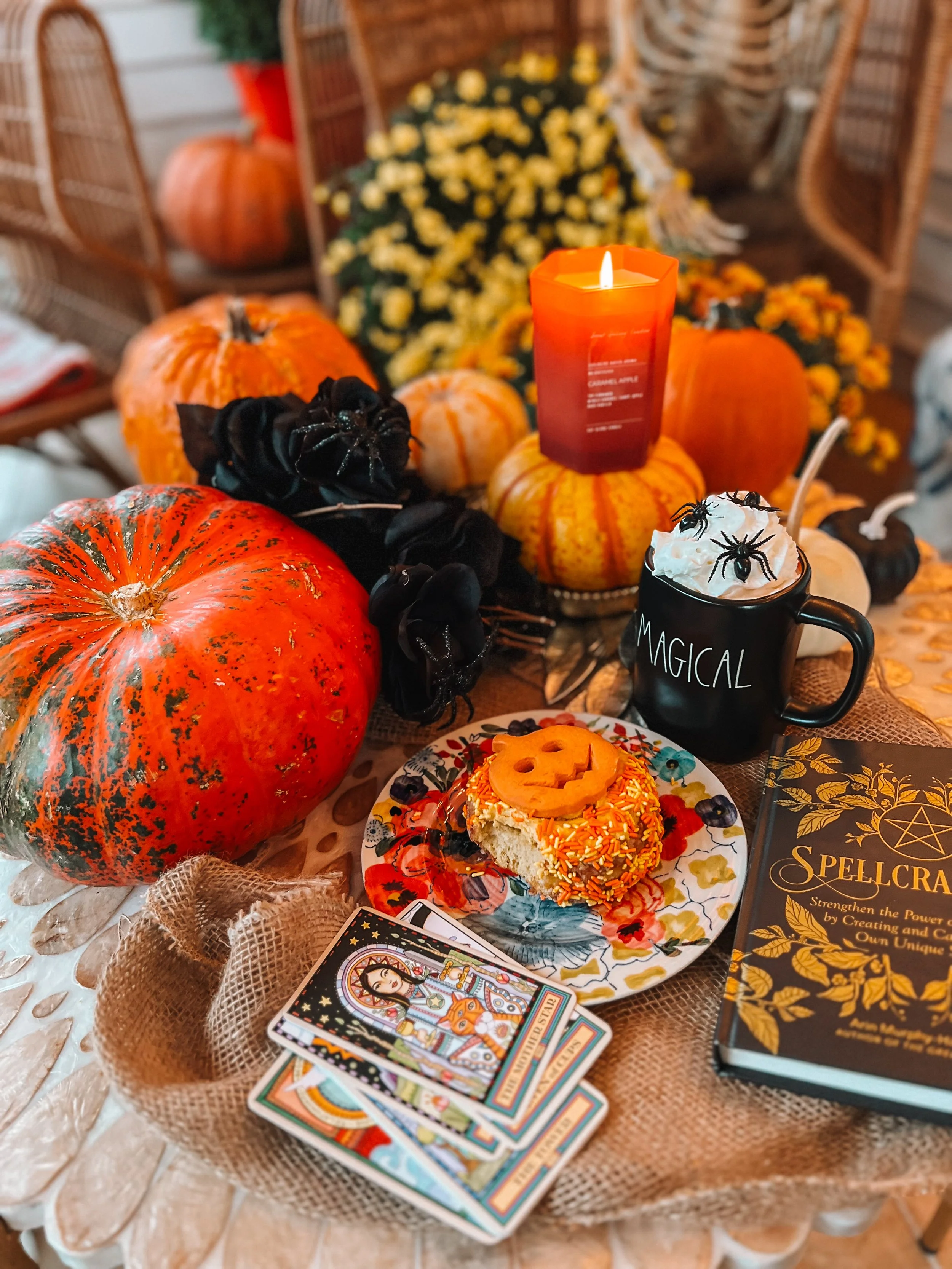 autumn scene with candles, tarot cards, and magical drinks.