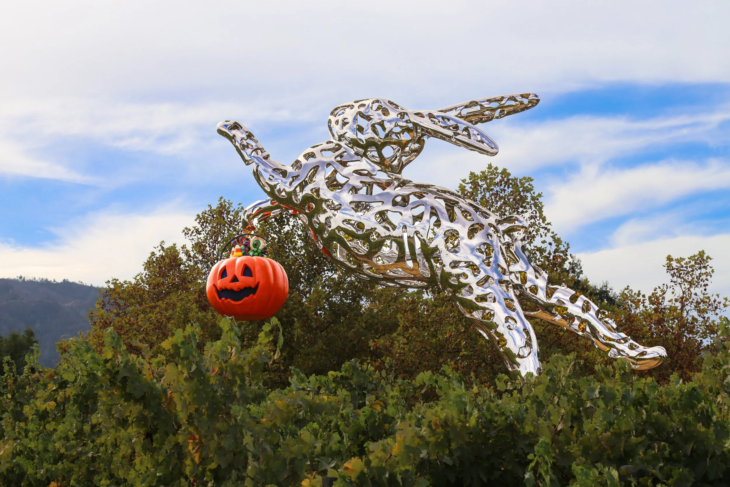 a 35 foot modern sculpture of a stainless steel rabbit leaping through the air