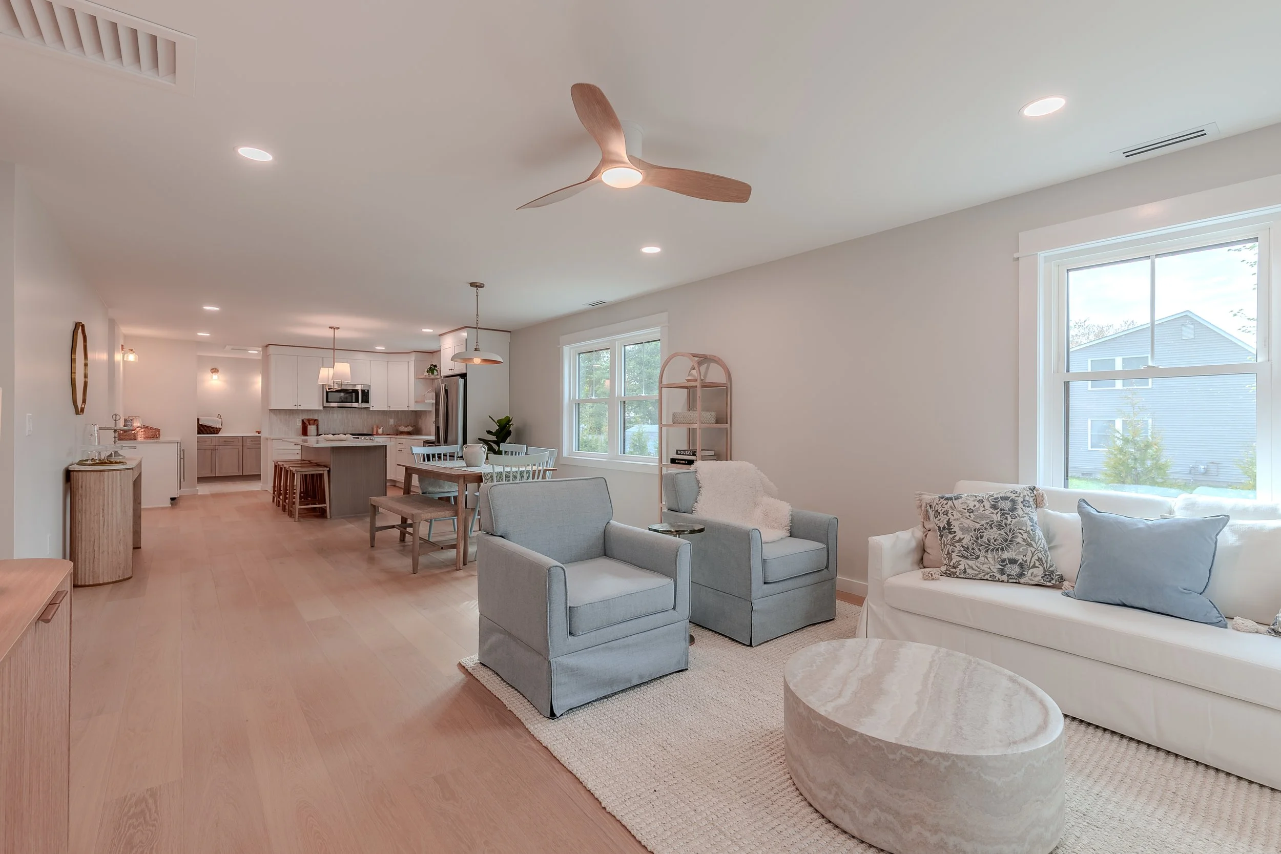 a gorgeous family room, dining room and kitchen on a shared floorplan in a brand new home.