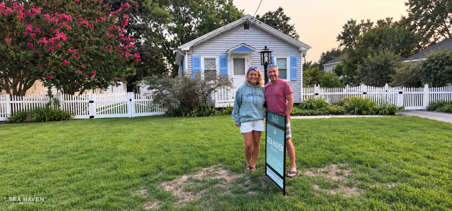 Kim and Joe with a Villas hoodie in front of their new cottage in Villas, NJ