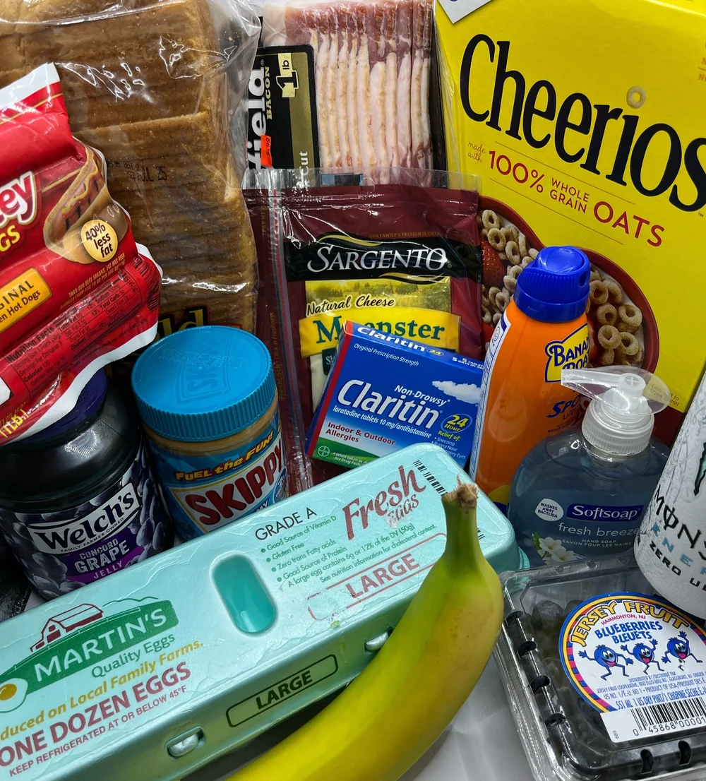 Groceries including bread, cereal, eggs, cheese, fruit and household essentials