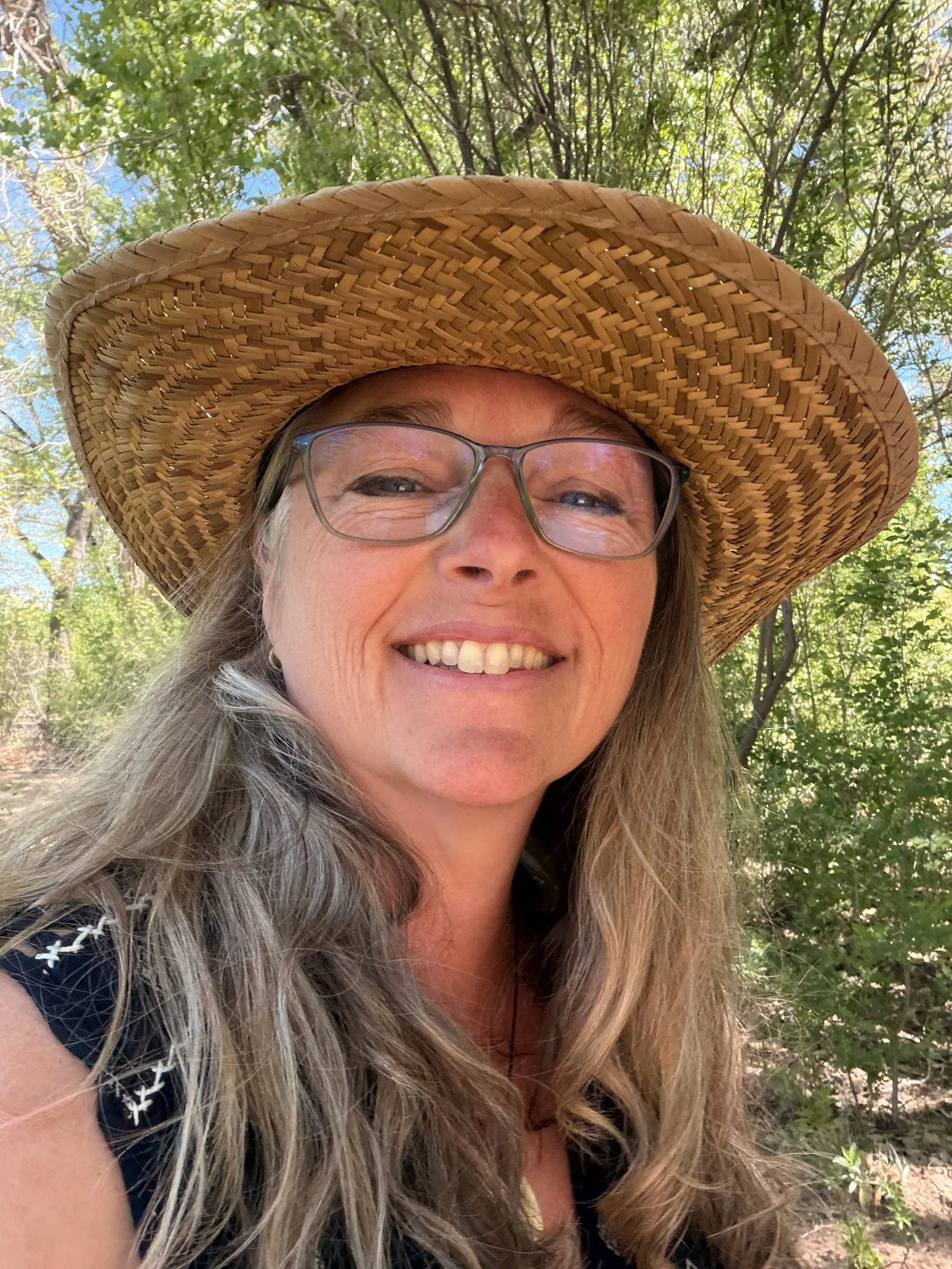 Photo of me out walking with my straw hat on and smiling..
