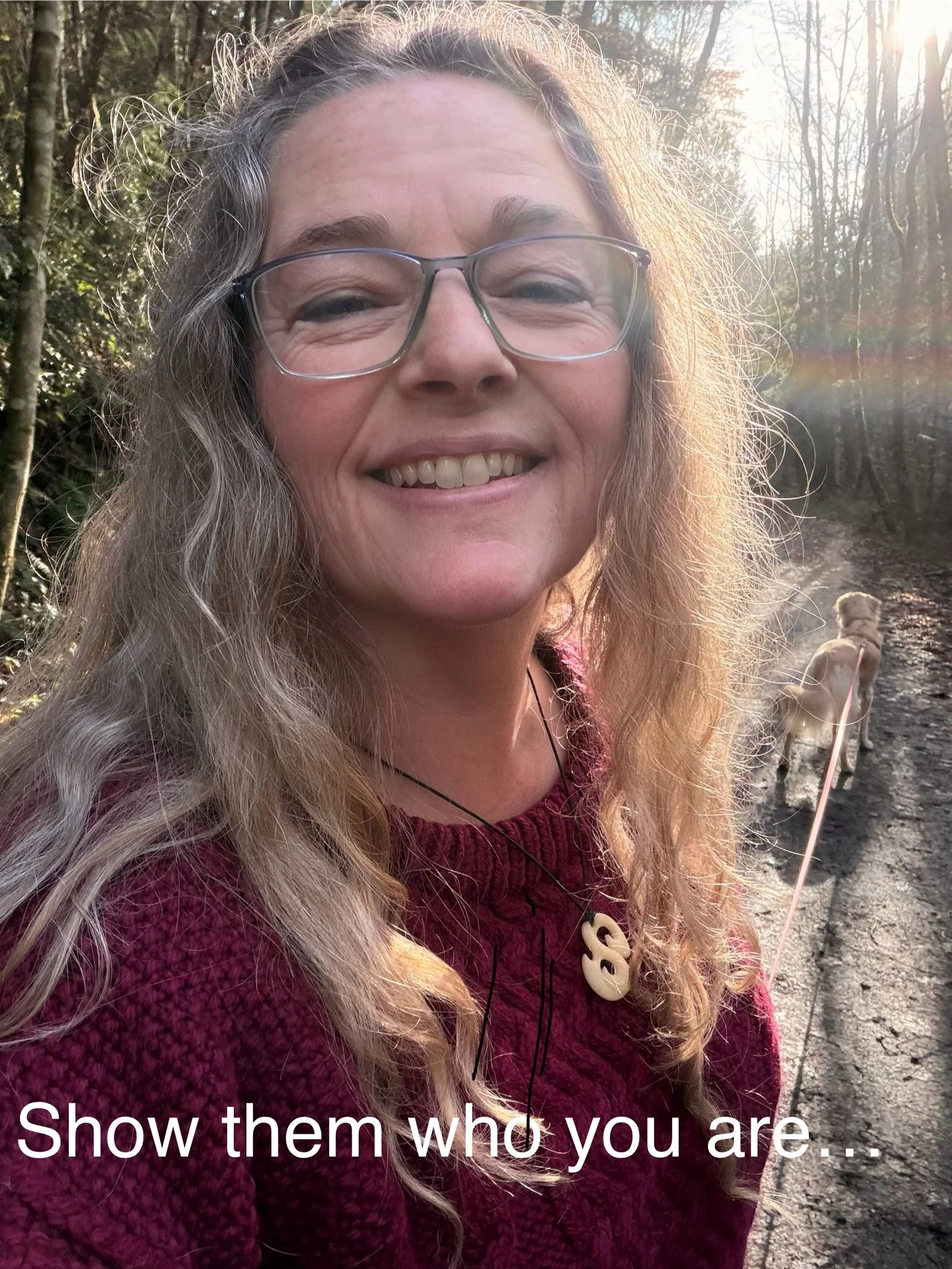 A photo of me smiling at the camera on a dog walk. The words on the photo say, "show them who you are..."