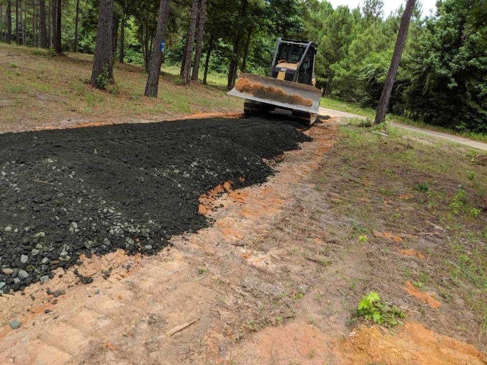 Here is a driveway that one of our employee's is spreading the Green Glauconite Road Base. 