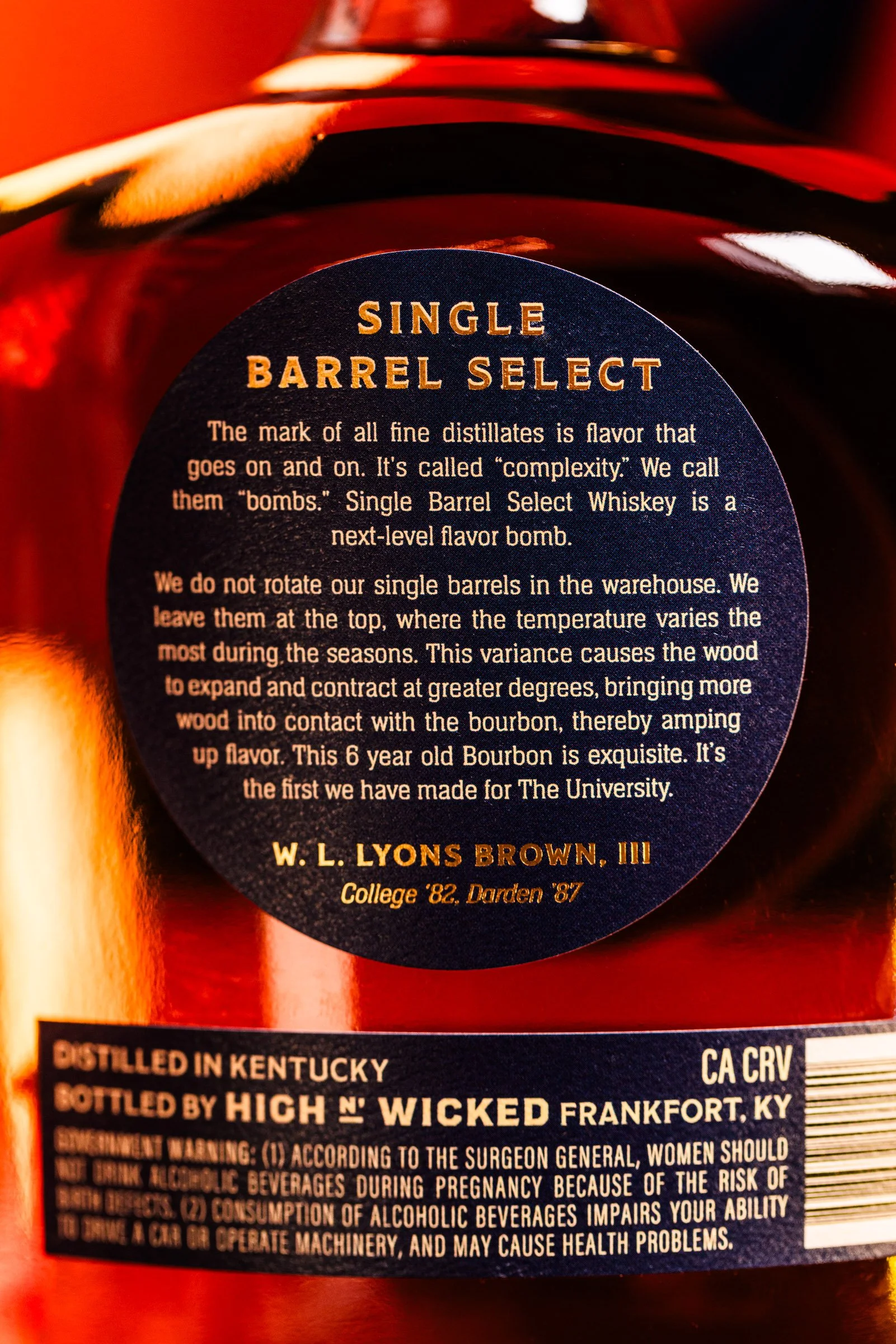 A close-up of the back label and description for the High n' Wicked Wahoo No. 1 Single Barrel Kentucky Straight Bourbon Whiskey bottle, 6 Year Old, UVA Collaboration - including a statement by W.L. Lyons Brown, III Alumni from UVA and Darden.