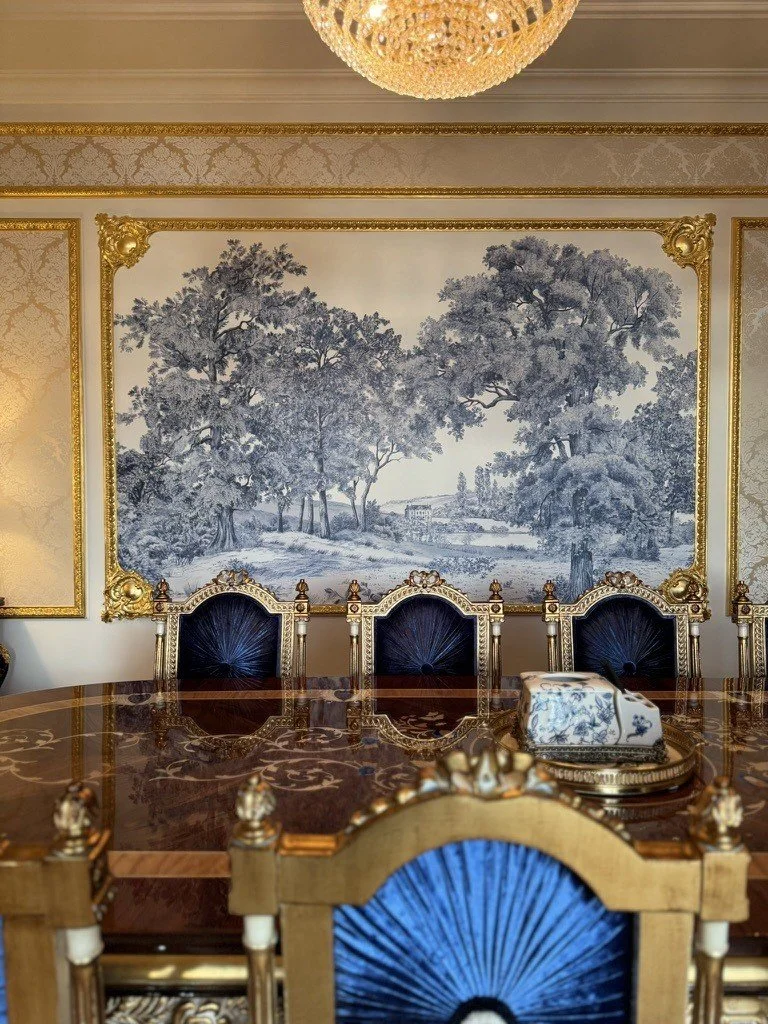 Blue and white wall artwork above a gilded console in the hotel residence.
