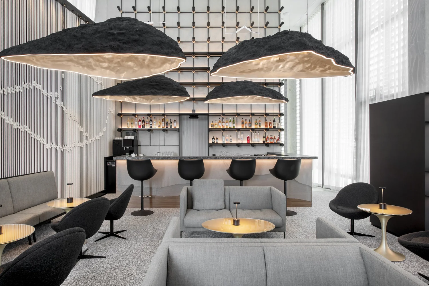 Hospitality lounge with bespoke lighting, seating and bar furnishings
