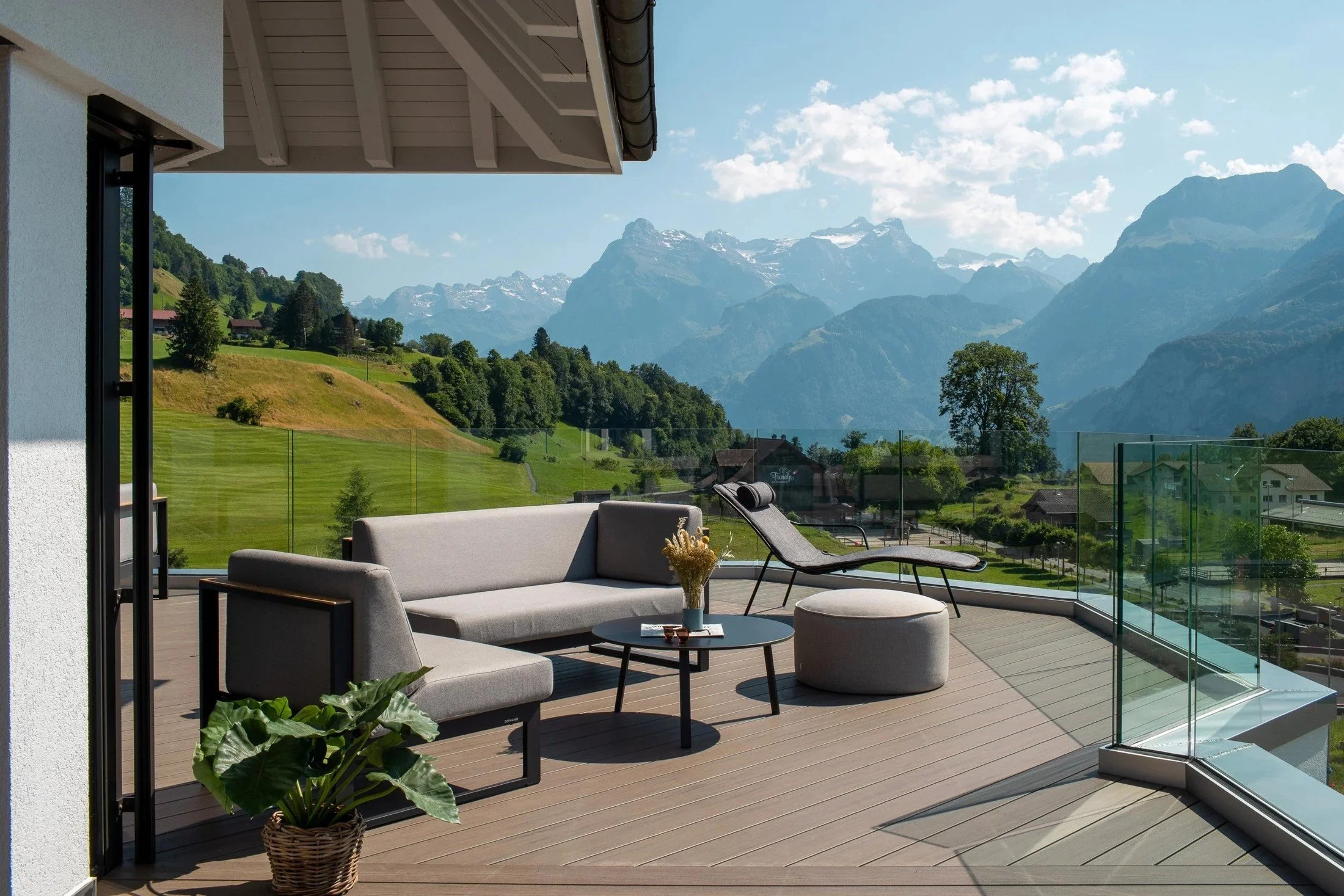 Outdoor resort seating area with views towards the surrounding mountains.