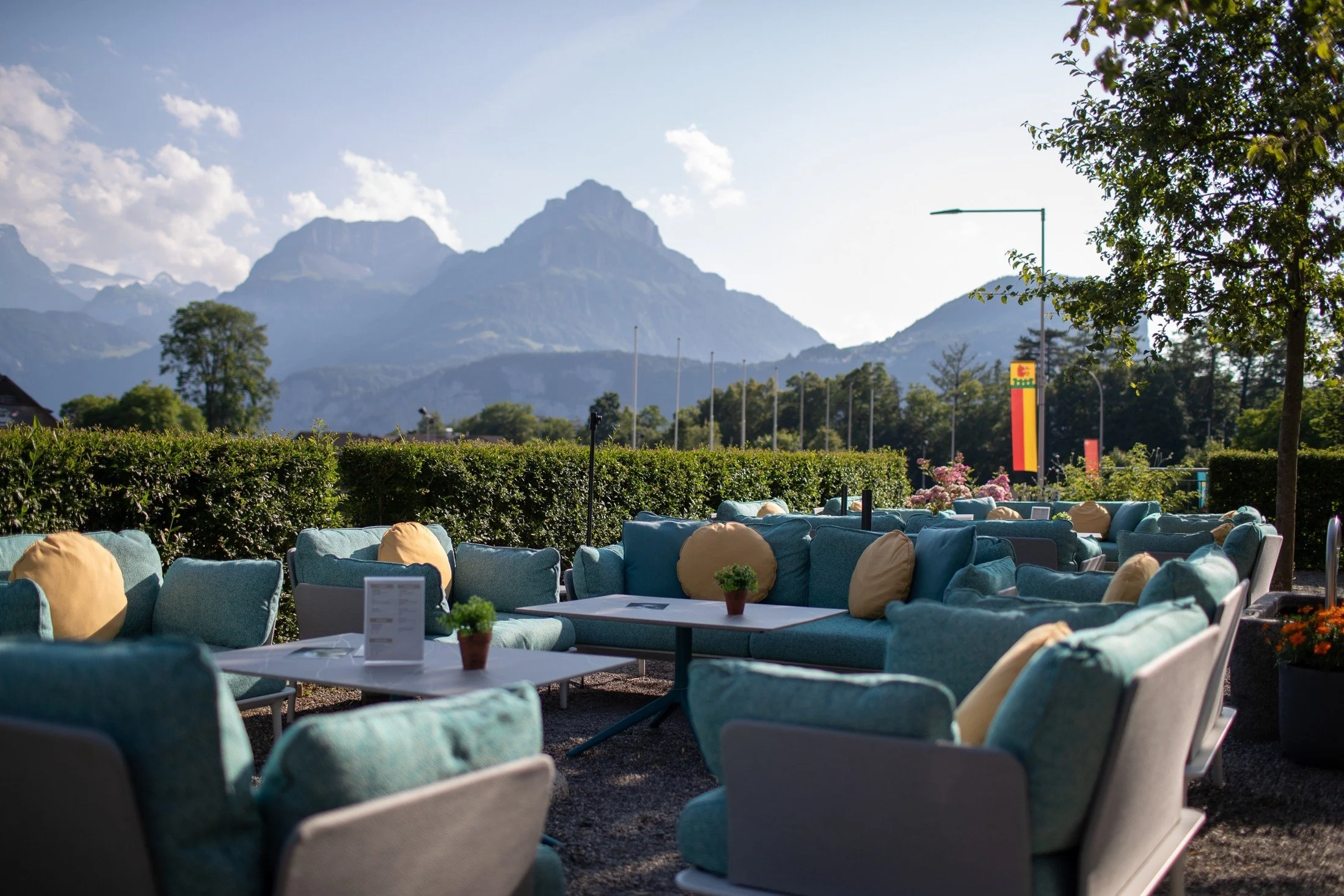 Outdoor lounge at Swiss Holiday Park with comfortable seating and views towards the surrounding mountains.