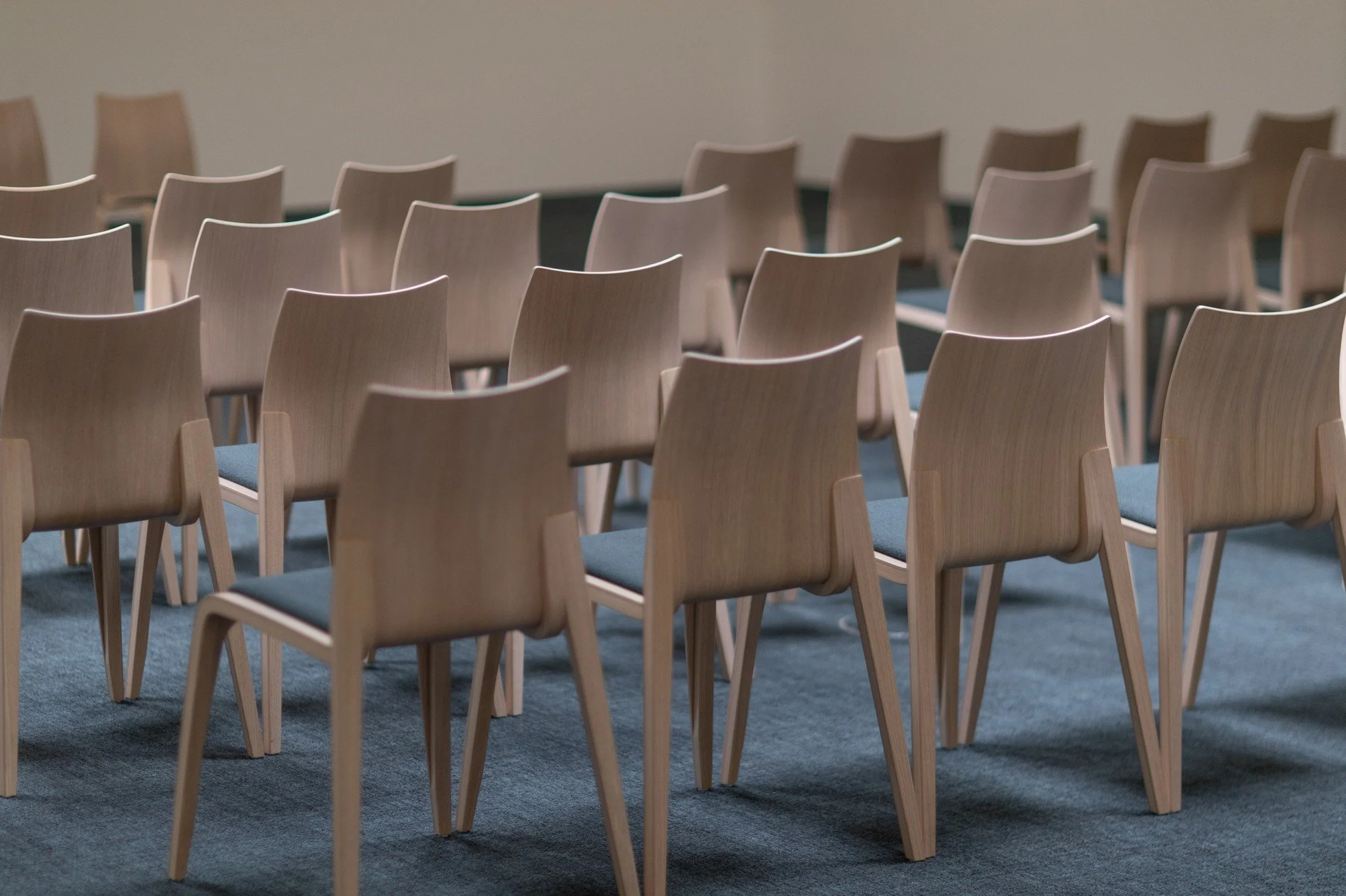 Rows of timber conference chairs arranged for a seminar at Swiss Holiday Park.