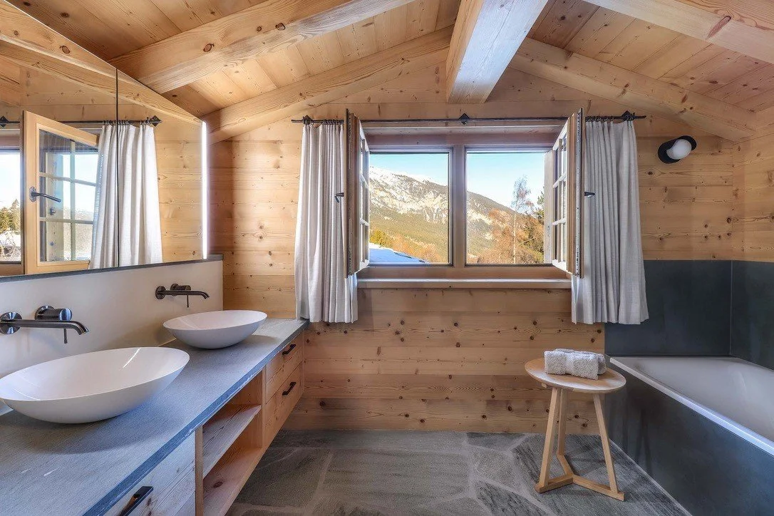 Timber-lined apartment bedroom overlooking the surrounding mountains.