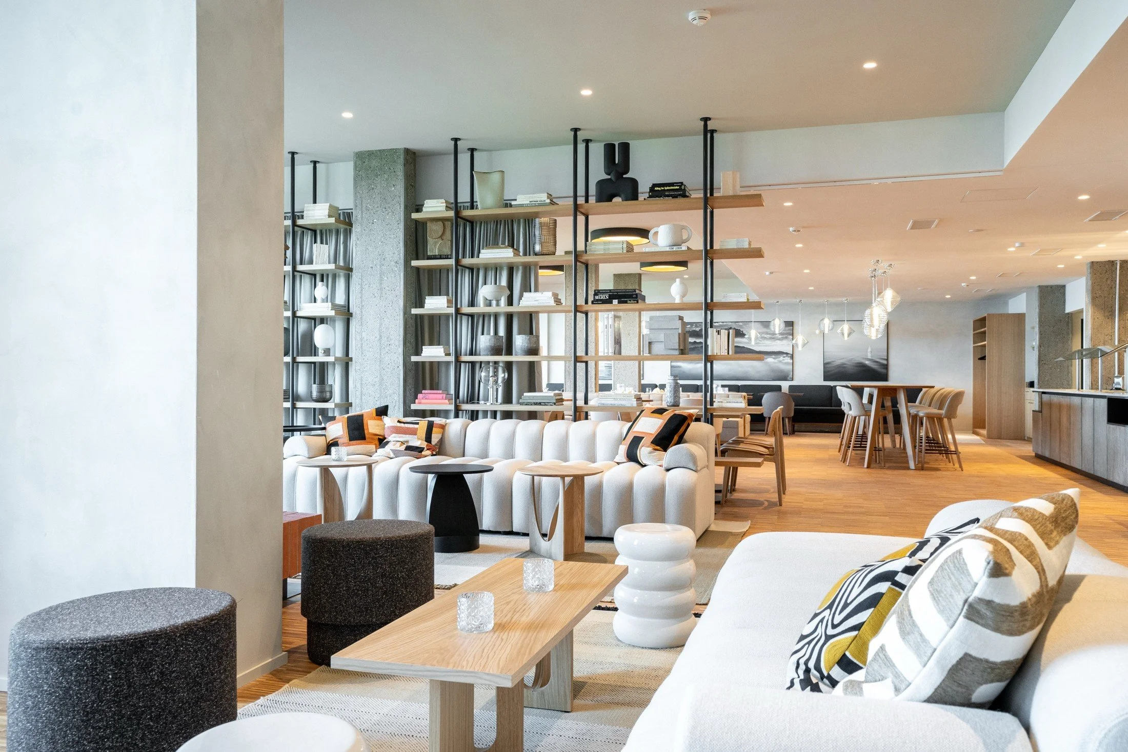 Hotel Heiden bar and restaurant with timber dining furniture and open display shelving.