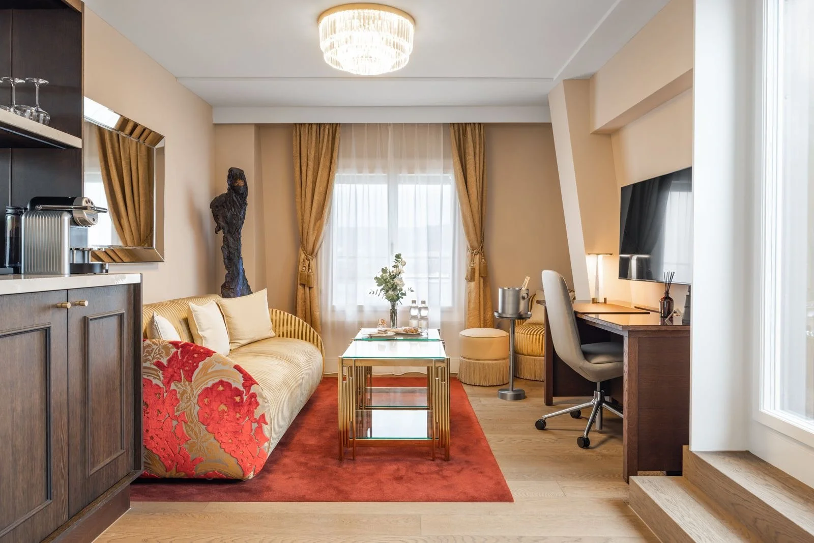 Grand Hotel National sitting room with floral upholstery and warm decorative details.