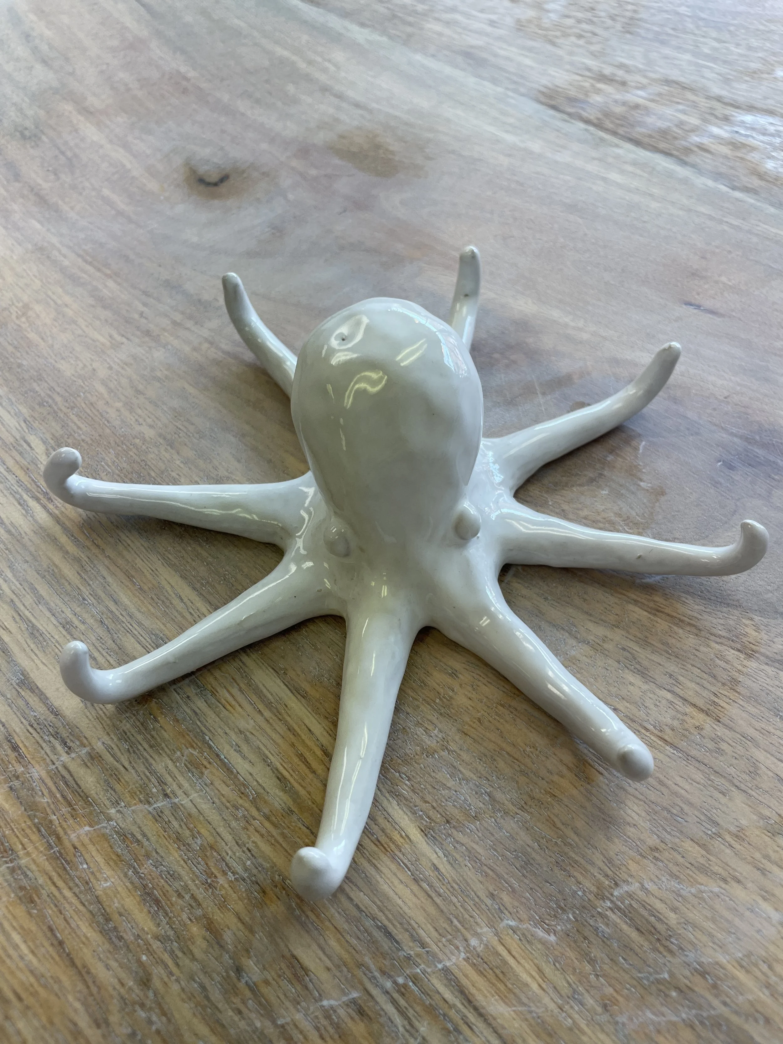 Ceramic octopus structure on wooden surface