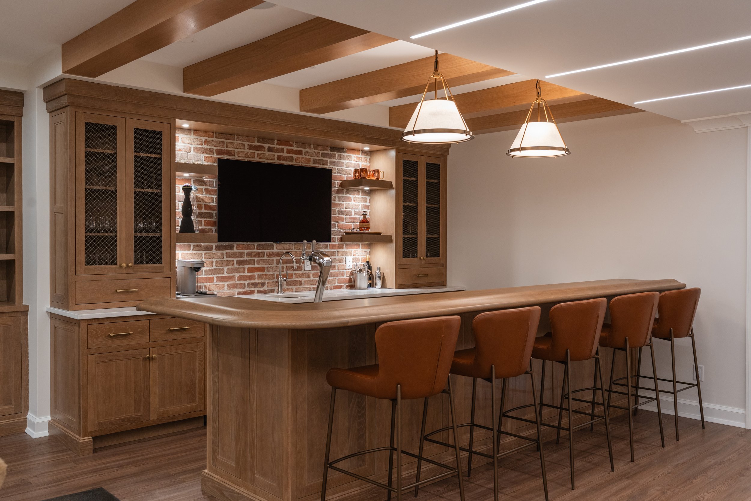 Custom Cabinetry and bar for a remodeled basement fabricated in Lebanon, NJ by Cora Cabinetry. Custom built by Cora Cabinetry for a project in Bergen County, NJ.