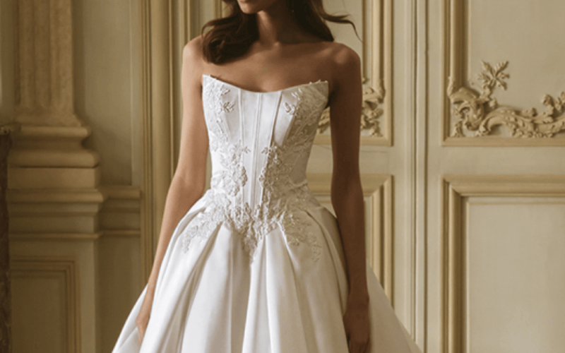 Strapless wedding dress with lace corset bodice featured in 2026 wedding dress trends.