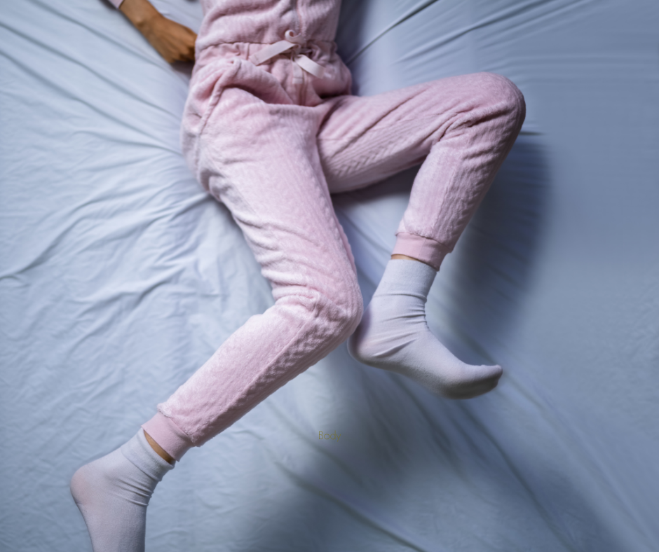 Child in pink pajamas lying on a bed with restless leg movement, illustrating how restless legs syndrome (RLS) can interfere with sleep in neurodivergent children.