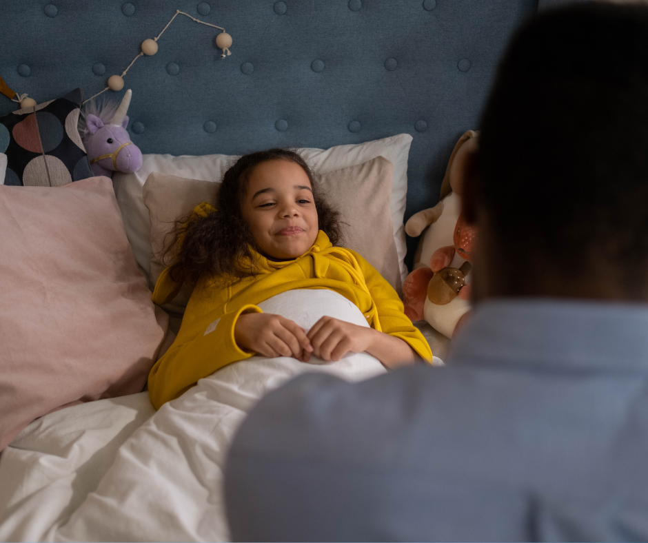 Father checking on his smiling daughter at bedtime, illustrating the importance of understanding and supporting neurodivergent children with sleep challenges.