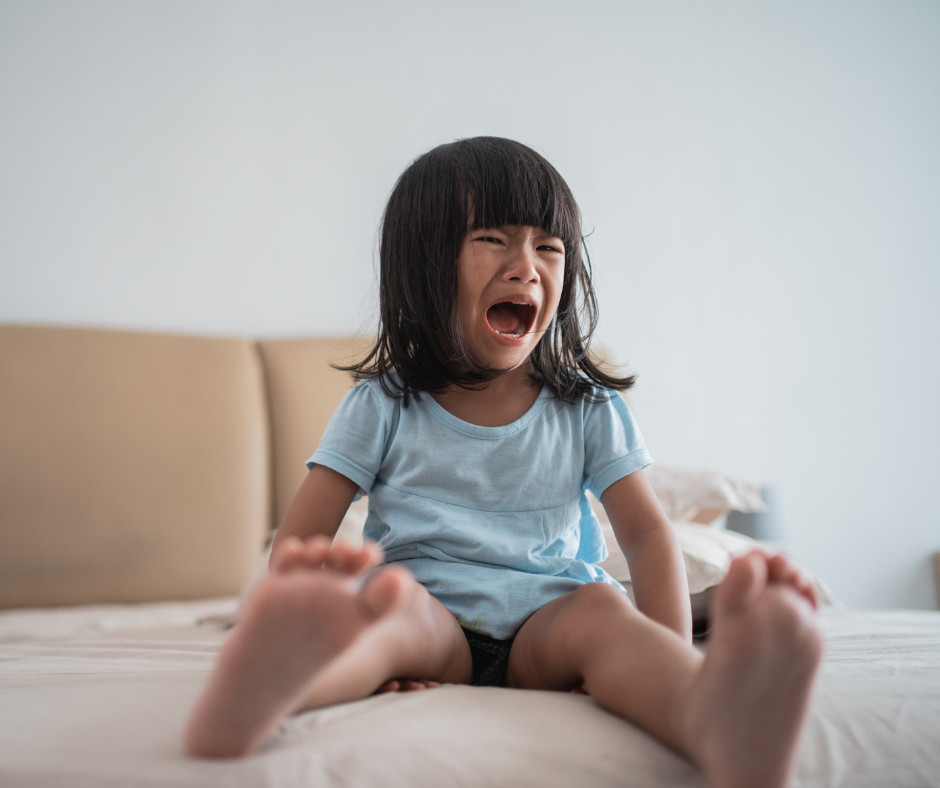 A young girl sits on her bed crying, unable to settle at bedtime. For many neurodivergent children, the end of the day brings a level of distress that conventional sleep advice doesn't account for.